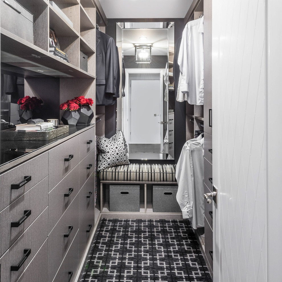 Inspiration for a large transitional men's carpeted and multicolored floor walk-in closet remodel in New York with flat-panel cabinets
