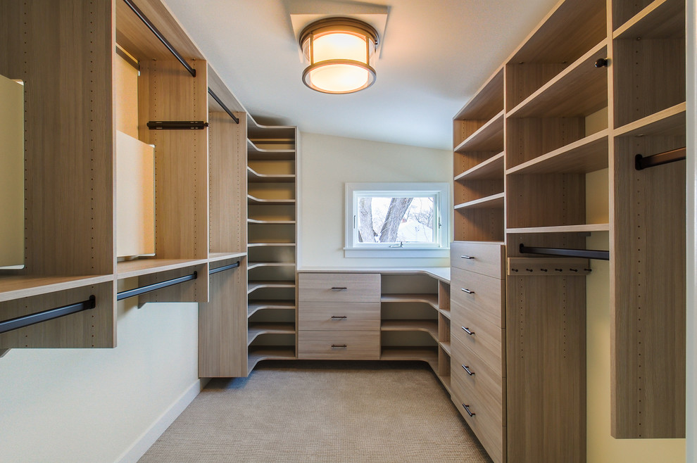 Inspiration for a medium sized contemporary gender neutral walk-in wardrobe in Minneapolis with flat-panel cabinets, light wood cabinets and carpet.