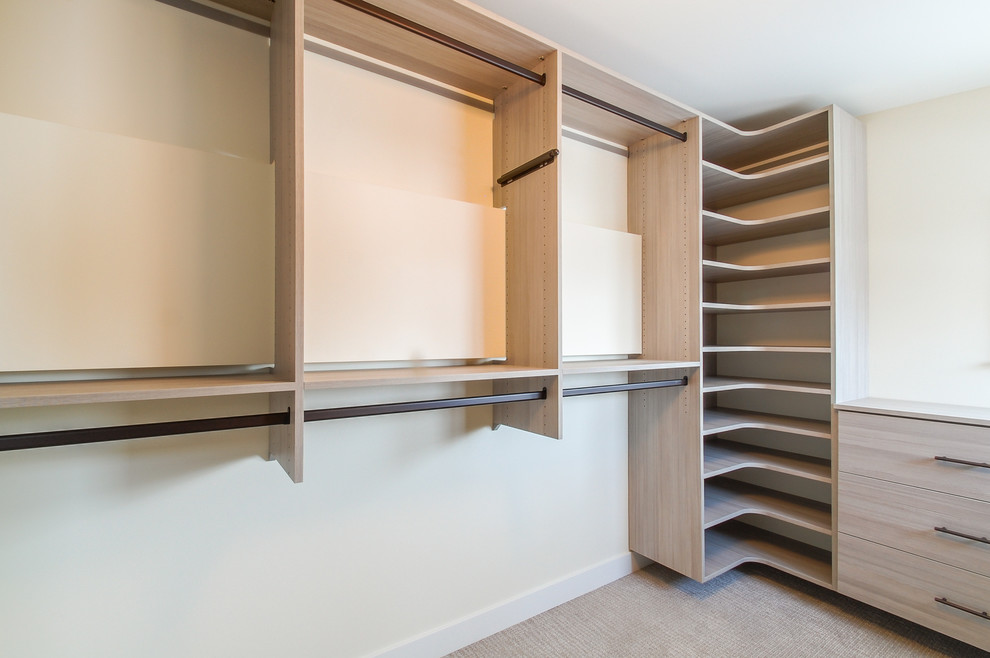 Inspiration for a medium sized contemporary gender neutral walk-in wardrobe in Minneapolis with flat-panel cabinets, light wood cabinets and carpet.
