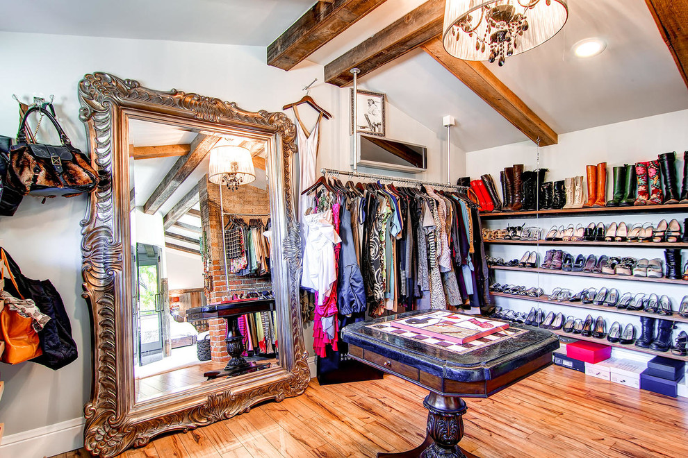 Foto de armario vestidor de mujer bohemio de tamaño medio con suelo de madera en tonos medios