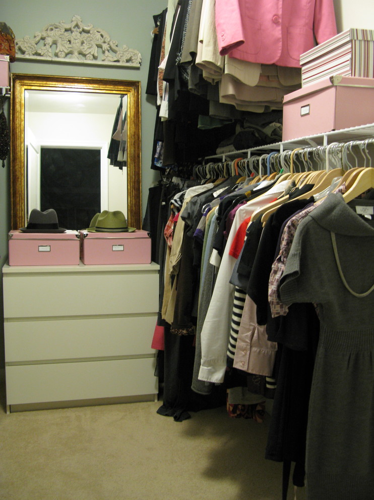 Inspiration for an eclectic women's walk-in closet remodel in Philadelphia with flat-panel cabinets and white cabinets
