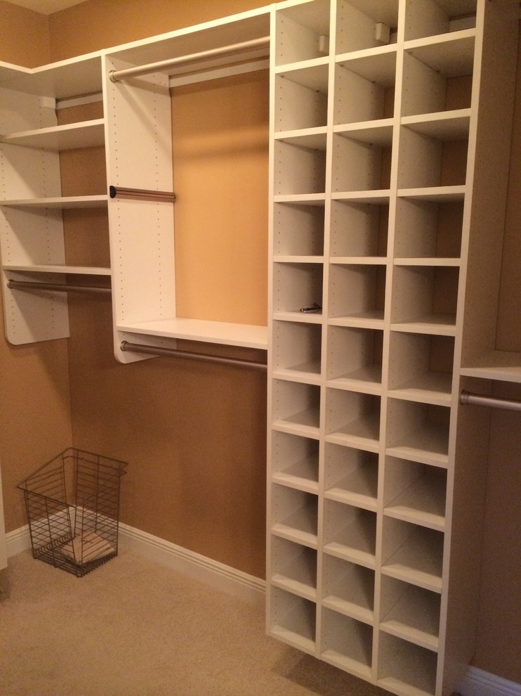 Photo of a large eclectic gender neutral walk-in wardrobe in Miami with shaker cabinets, white cabinets, carpet and beige floors.