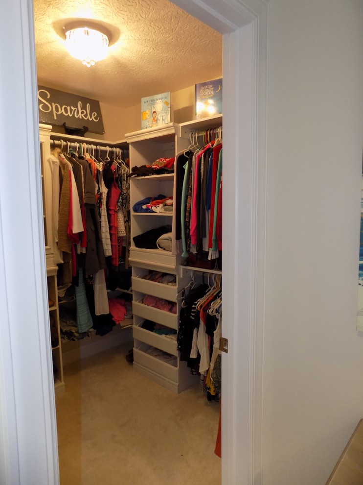 Design ideas for a medium sized nautical walk-in wardrobe for women in Columbus with glass-front cabinets, white cabinets, carpet and white floors.