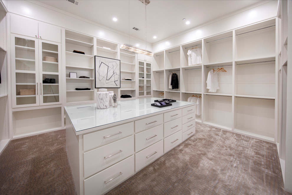 Design ideas for a large contemporary gender neutral walk-in wardrobe in Dallas with flat-panel cabinets, white cabinets and carpet.