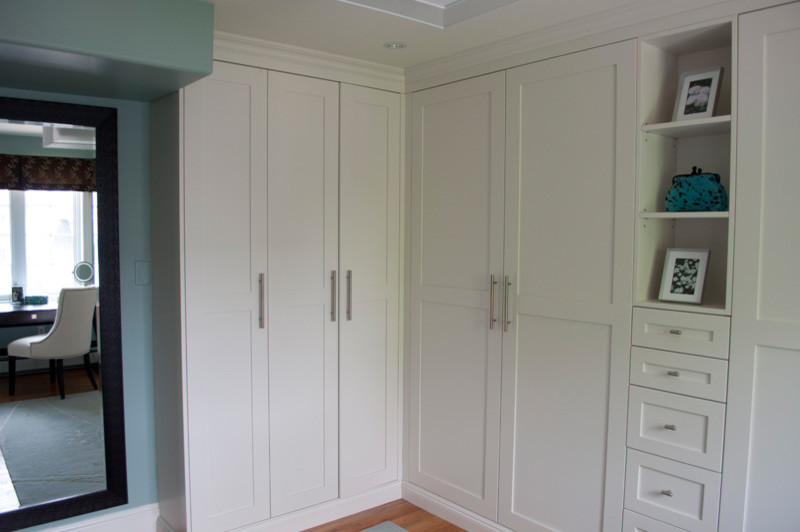 Design ideas for a classic dressing room in Other with shaker cabinets, white cabinets and light hardwood flooring.