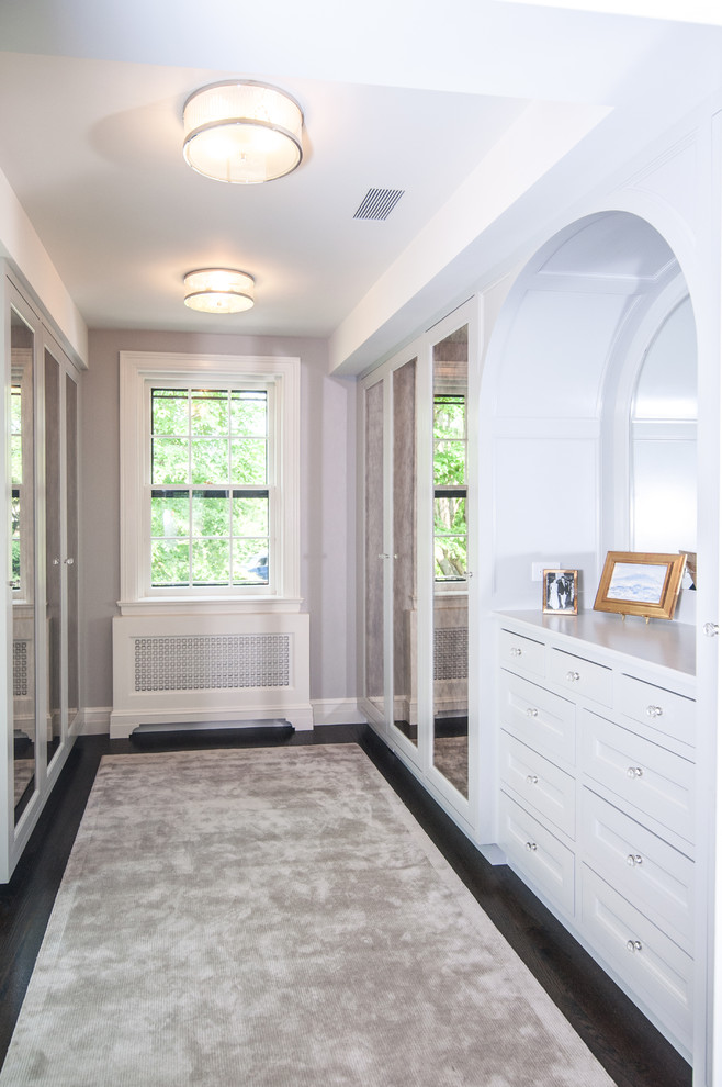 Inspiration for a huge transitional women's dark wood floor dressing room remodel in New York with shaker cabinets and white cabinets