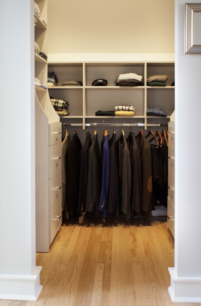 Walk-in closet - small contemporary men's light wood floor walk-in closet idea in New York with flat-panel cabinets and light wood cabinets