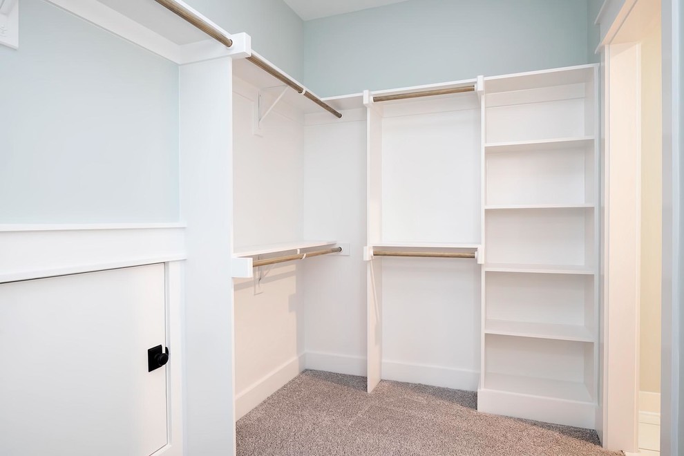 Large elegant gender-neutral carpeted and gray floor walk-in closet photo in Raleigh with open cabinets and white cabinets