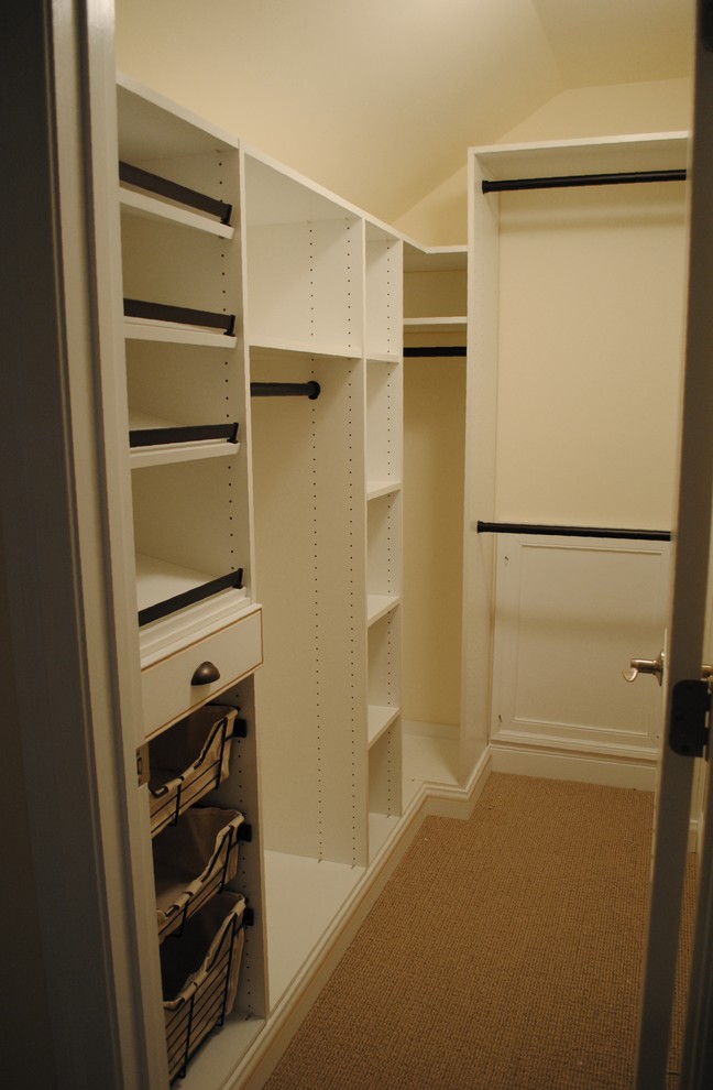 Traditional walk-in wardrobe in DC Metro with white cabinets and carpet.
