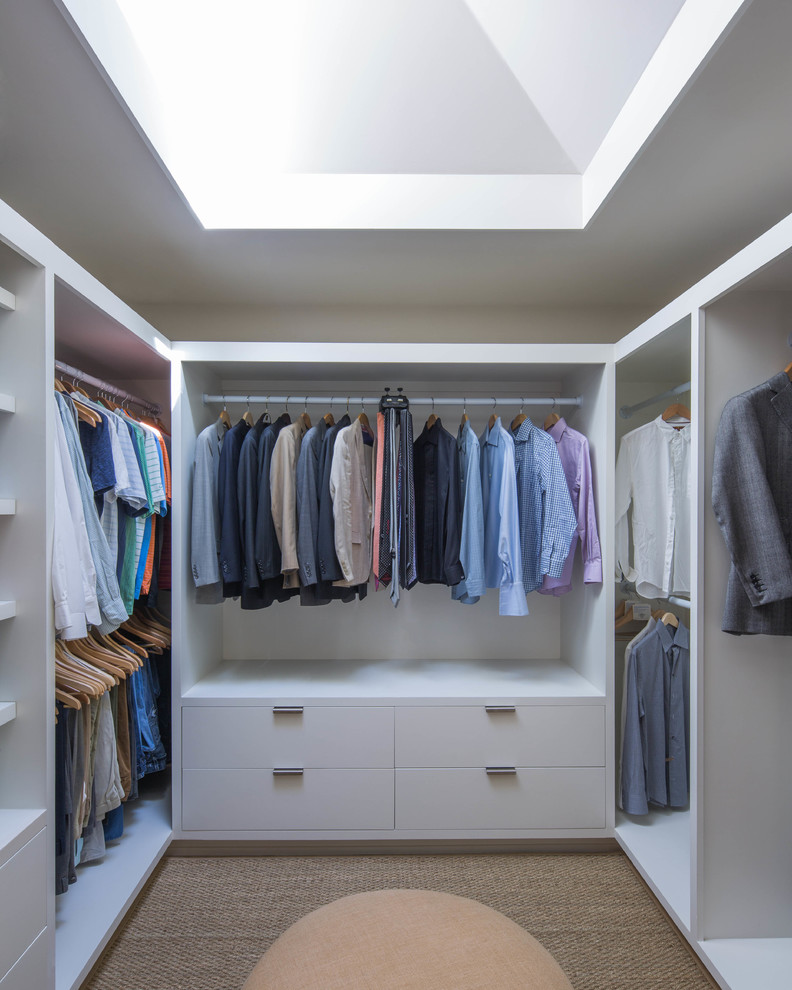 This is an example of a contemporary walk-in wardrobe in Austin with white cabinets and open cabinets.