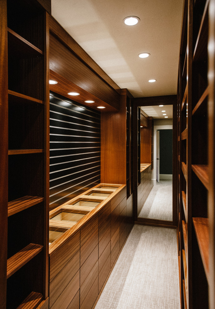 Inspiration for a mid-sized contemporary gender-neutral carpeted and gray floor walk-in closet remodel in Portland with flat-panel cabinets and medium tone wood cabinets