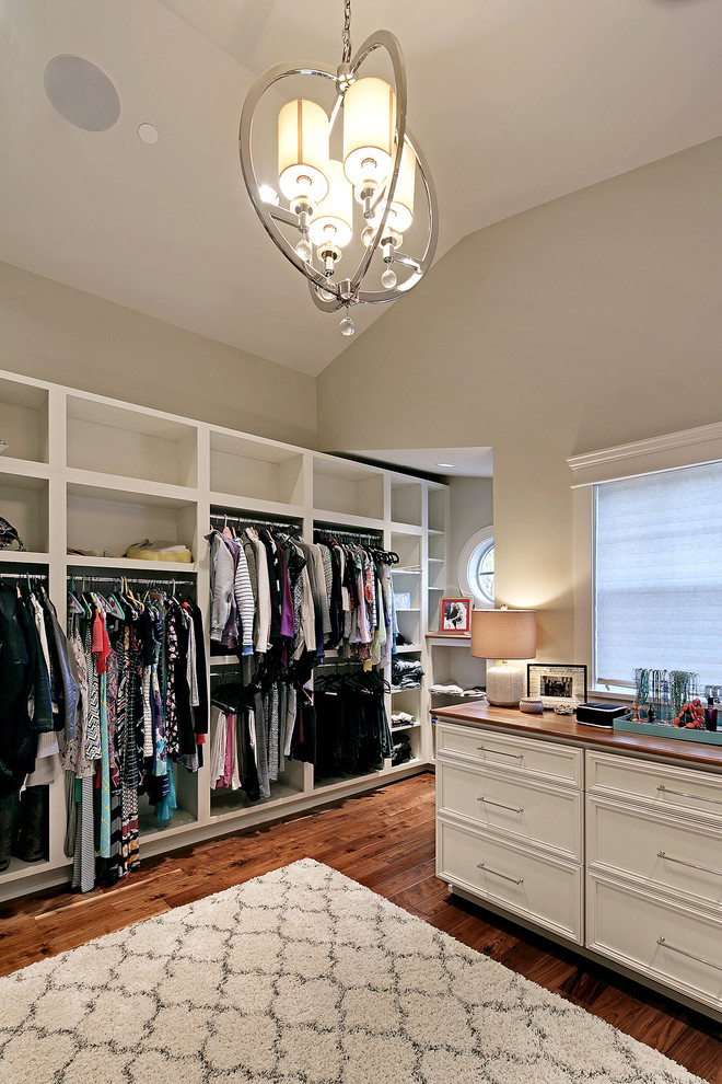 Inspiration for an expansive traditional gender neutral walk-in wardrobe in Seattle with recessed-panel cabinets, white cabinets and dark hardwood flooring.