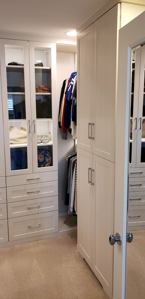 Inspiration for a large traditional gender neutral walk-in wardrobe in Indianapolis with shaker cabinets, white cabinets and carpet.