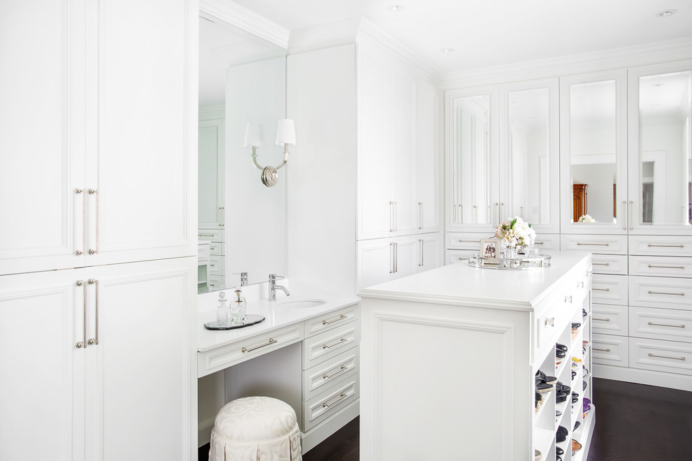 Inspiration for a classic dressing room for women in Montreal with recessed-panel cabinets, white cabinets and dark hardwood flooring.