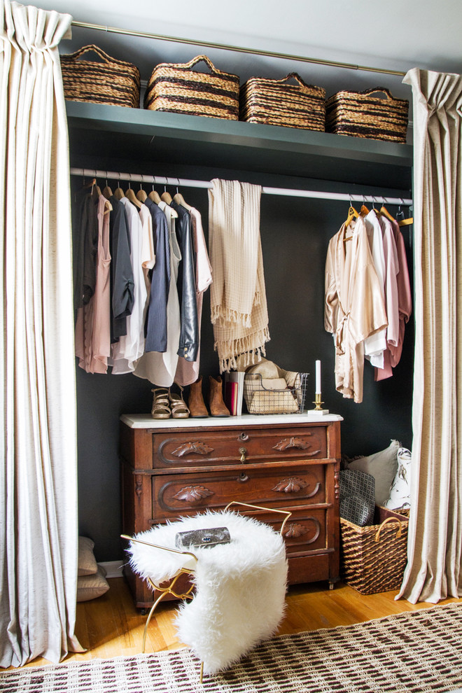 Reach-in closet - transitional medium tone wood floor reach-in closet idea in Chicago