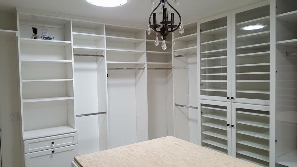 Large elegant women's walk-in closet photo in Los Angeles with recessed-panel cabinets and white cabinets