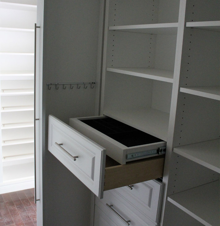 Photo of a large classic gender neutral walk-in wardrobe in Toronto with raised-panel cabinets, white cabinets and dark hardwood flooring.