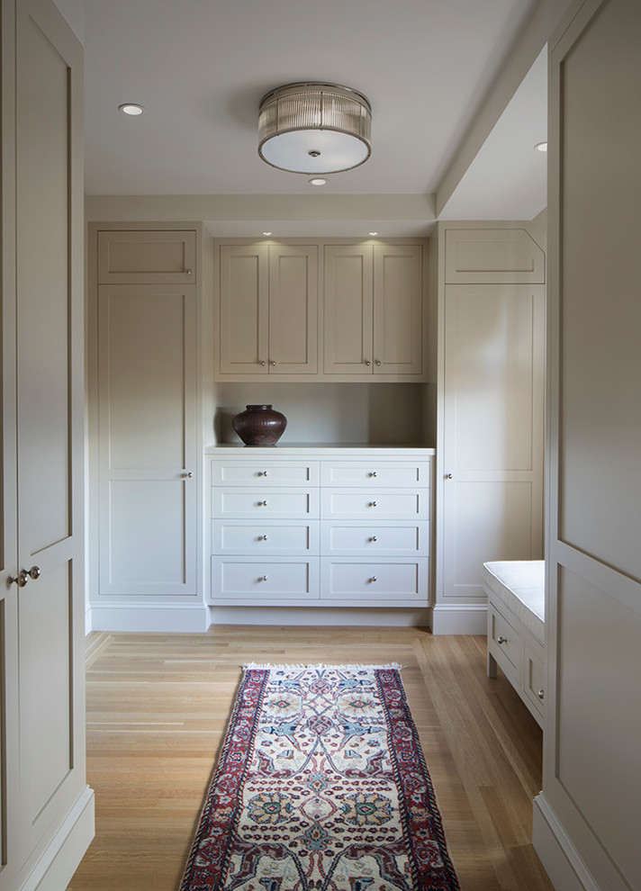 Walk-in closet - large traditional gender-neutral light wood floor walk-in closet idea in San Francisco with recessed-panel cabinets and gray cabinets