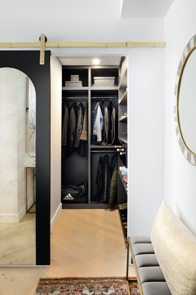 This is an example of a medium sized contemporary walk-in wardrobe in Toronto with open cabinets, light hardwood flooring and beige floors.