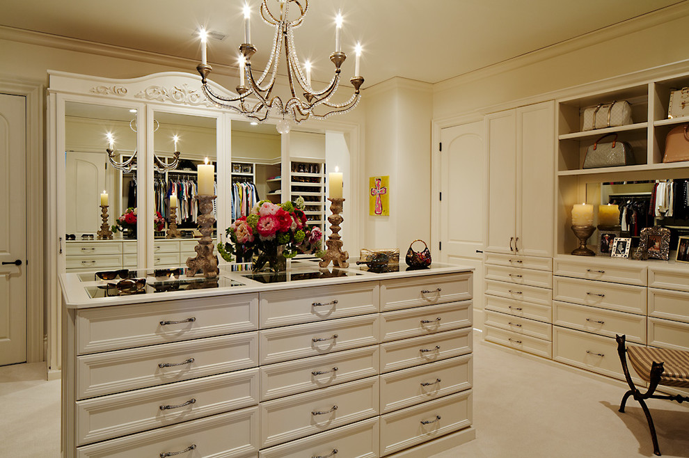 Example of a large classic women's carpeted walk-in closet design in Nashville with recessed-panel cabinets and white cabinets