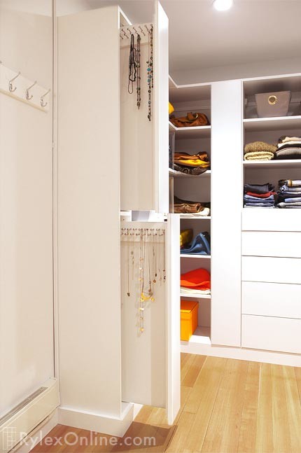 Contemporary wardrobe in New York with flat-panel cabinets and white cabinets.