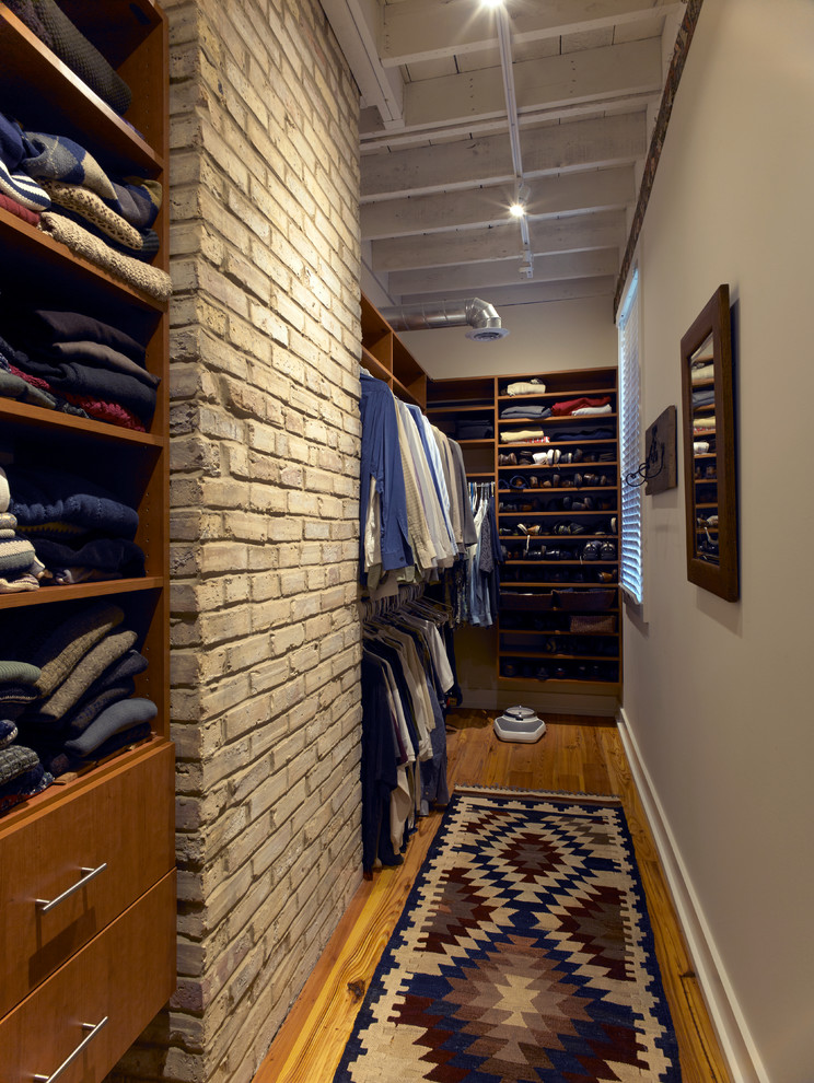 Walk-in closet - mid-sized industrial men's medium tone wood floor walk-in closet idea in Chicago with flat-panel cabinets and medium tone wood cabinets
