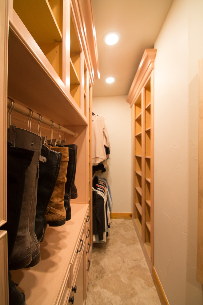 Foto de armario vestidor unisex tradicional grande con armarios con paneles con relieve, puertas de armario de madera clara, suelo de travertino y suelo beige