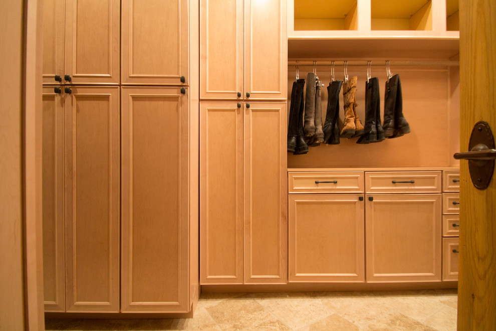 Inspiration for a large classic gender neutral walk-in wardrobe in Denver with raised-panel cabinets, light wood cabinets, travertine flooring and beige floors.