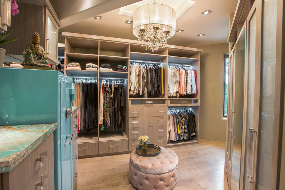 Inspiration for a large traditional gender neutral walk-in wardrobe in Denver with flat-panel cabinets, medium wood cabinets and medium hardwood flooring.
