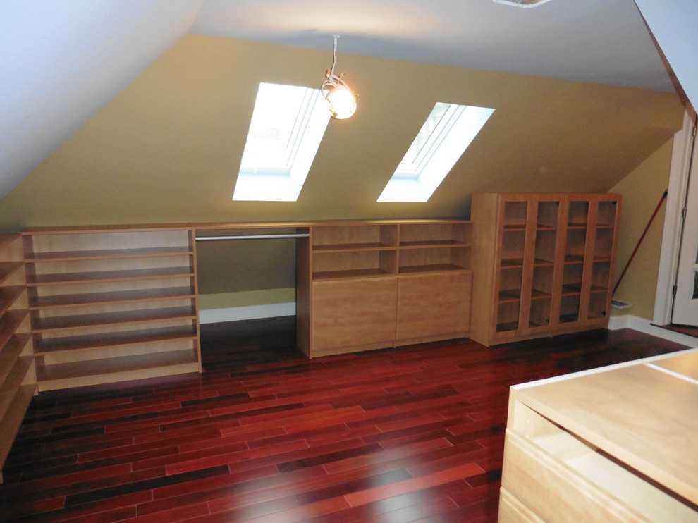 Imagen de armario vestidor unisex de tamaño medio con armarios abiertos, puertas de armario de madera oscura y suelo de madera en tonos medios