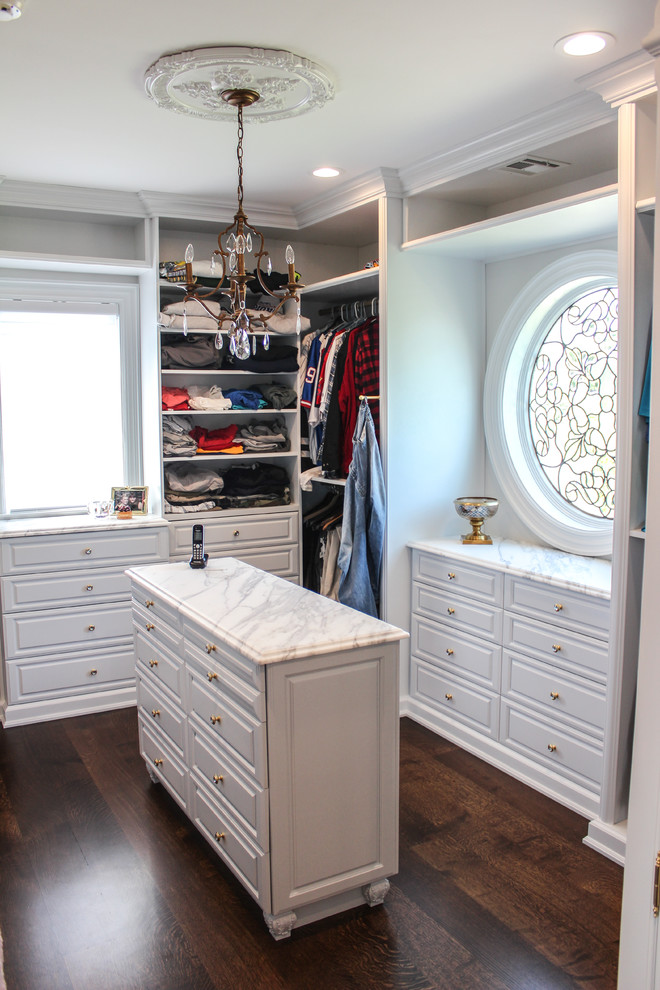 Inspiration for a large shabby-chic style gender-neutral dark wood floor walk-in closet remodel in New York with open cabinets and white cabinets