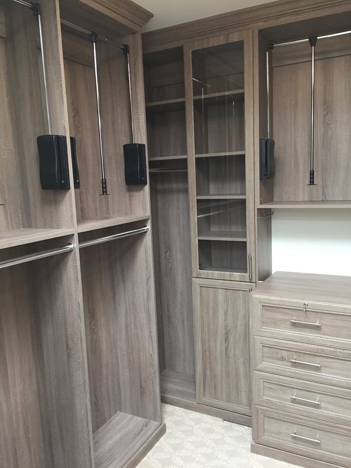 Inspiration for a mid-sized contemporary gender-neutral carpeted and beige floor walk-in closet remodel in Atlanta with recessed-panel cabinets and light wood cabinets