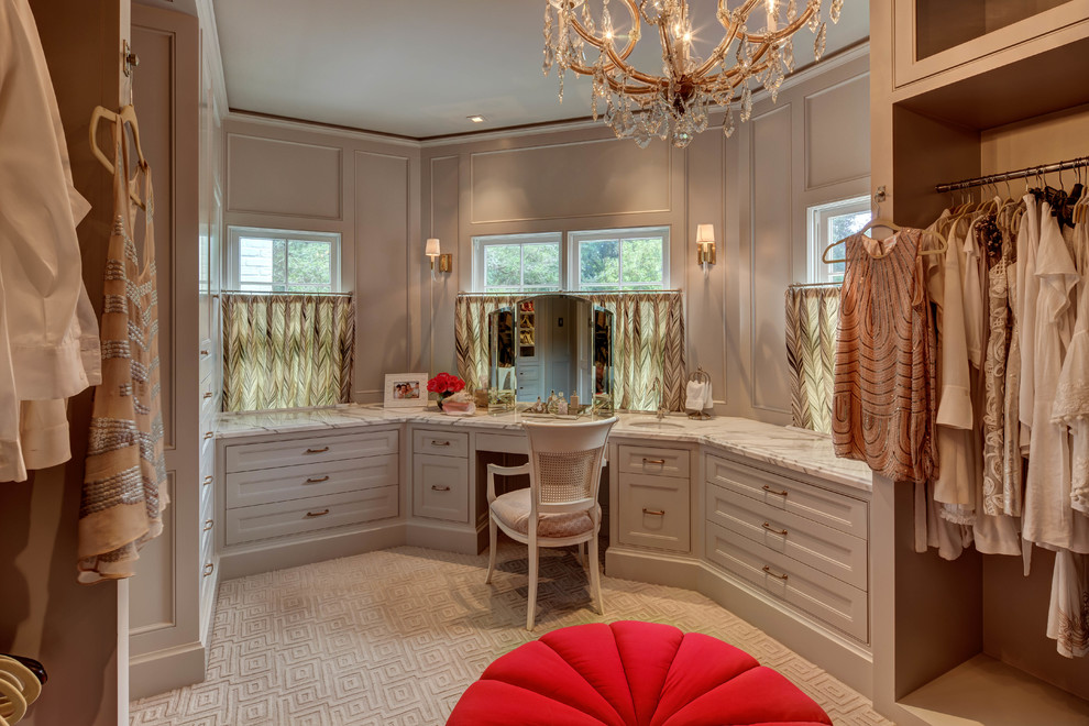 This is an example of a traditional dressing room for women in Houston with raised-panel cabinets, grey cabinets and carpet.