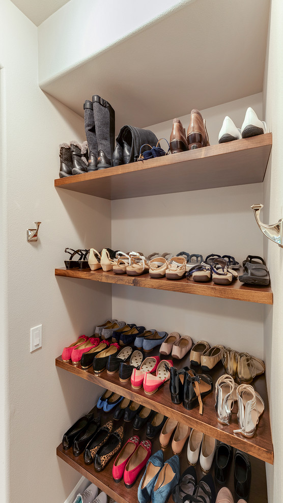 Photo of a small contemporary walk-in wardrobe for women in Other with carpet and beige floors.