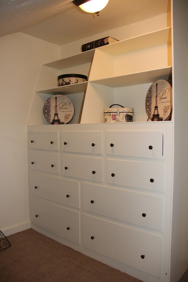 Medium sized classic walk-in wardrobe for women in Other with white cabinets and carpet.