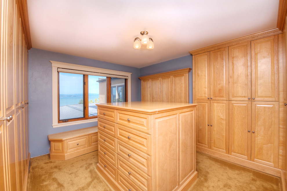 Large tuscan gender-neutral carpeted dressing room photo in San Francisco with raised-panel cabinets and light wood cabinets