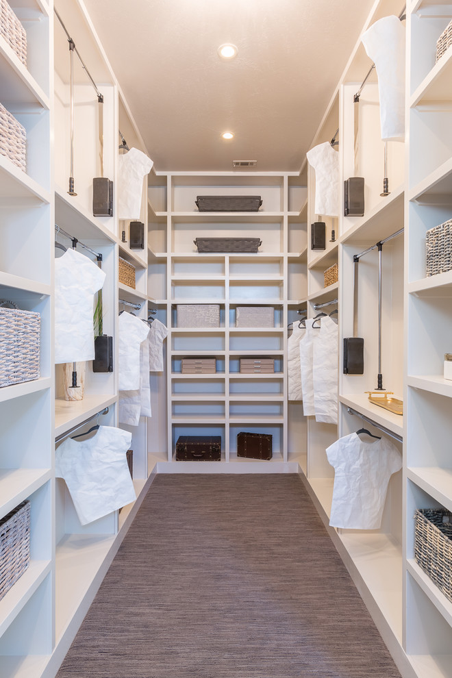 Example of a large cottage walk-in closet design in Austin