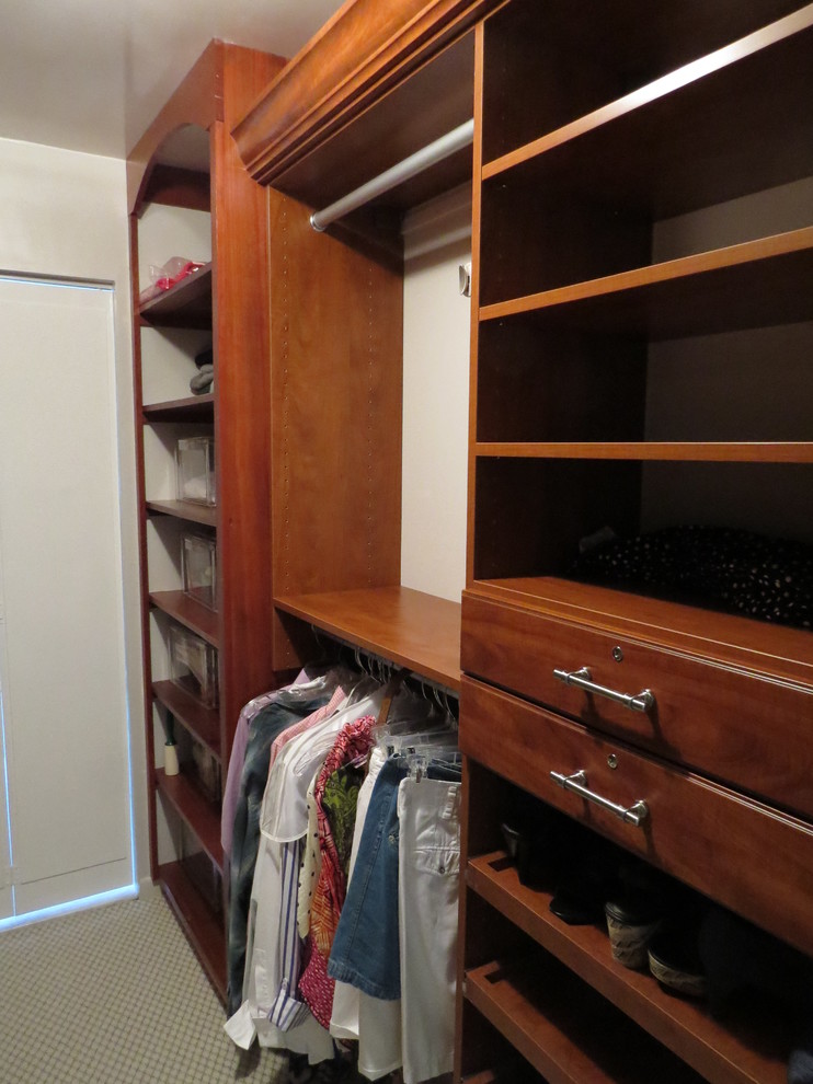 Example of a mid-sized country walk-in closet design in Boston
