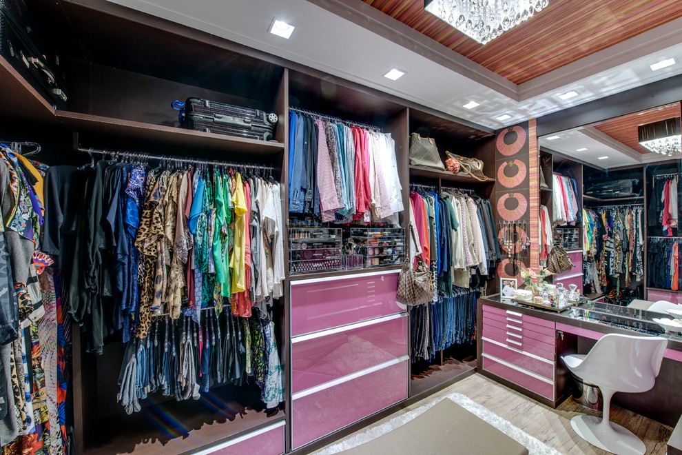 Inspiration for a large contemporary wardrobe for women in Other with dark wood cabinets and open cabinets.