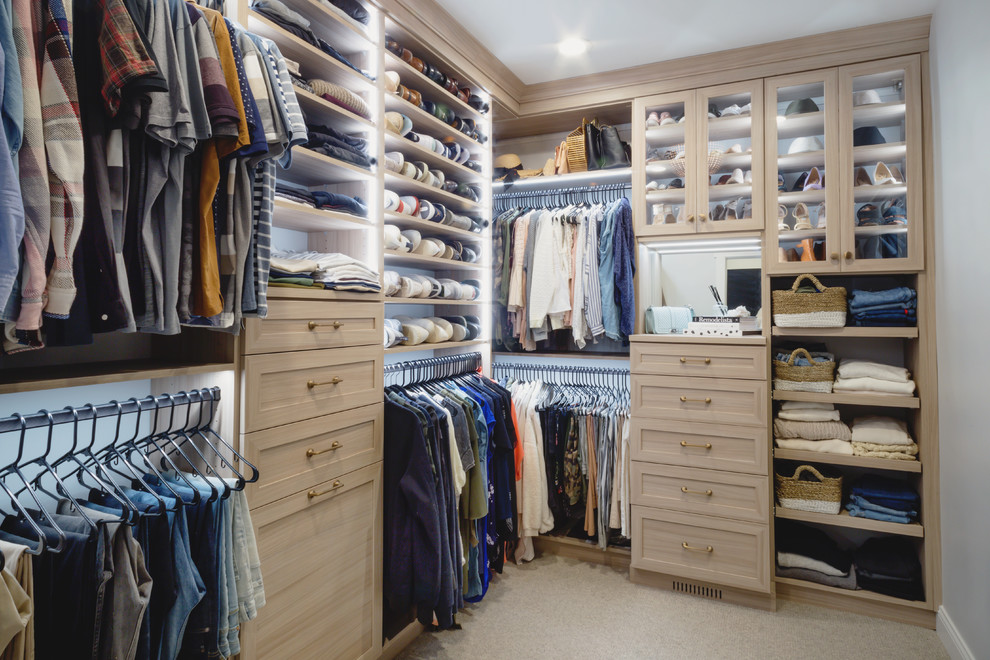 Example of a mid-sized transitional gender-neutral carpeted and beige floor walk-in closet design in Minneapolis with shaker cabinets and medium tone wood cabinets