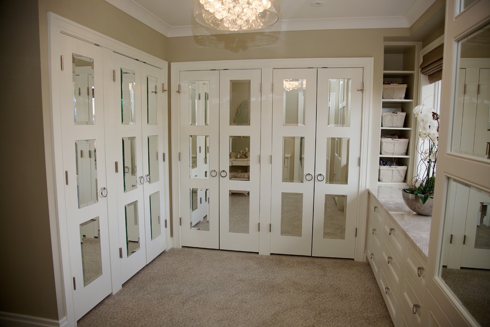 Example of a mid-sized transitional gender-neutral carpeted and beige floor dressing room design in Toronto with raised-panel cabinets and beige cabinets
