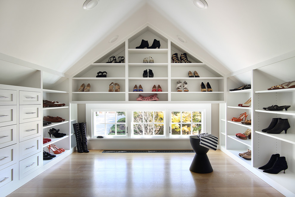 Inspiration for a transitional light wood floor and beige floor dressing room remodel in New York with open cabinets and white cabinets
