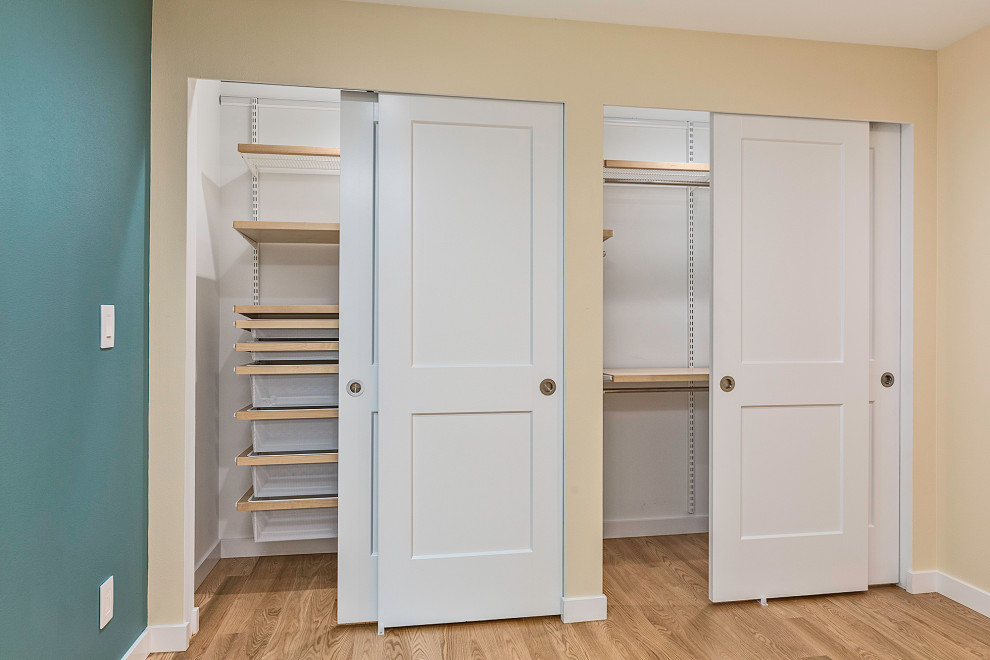 Inspiration for a medium sized contemporary standard wardrobe in Seattle with light hardwood flooring.
