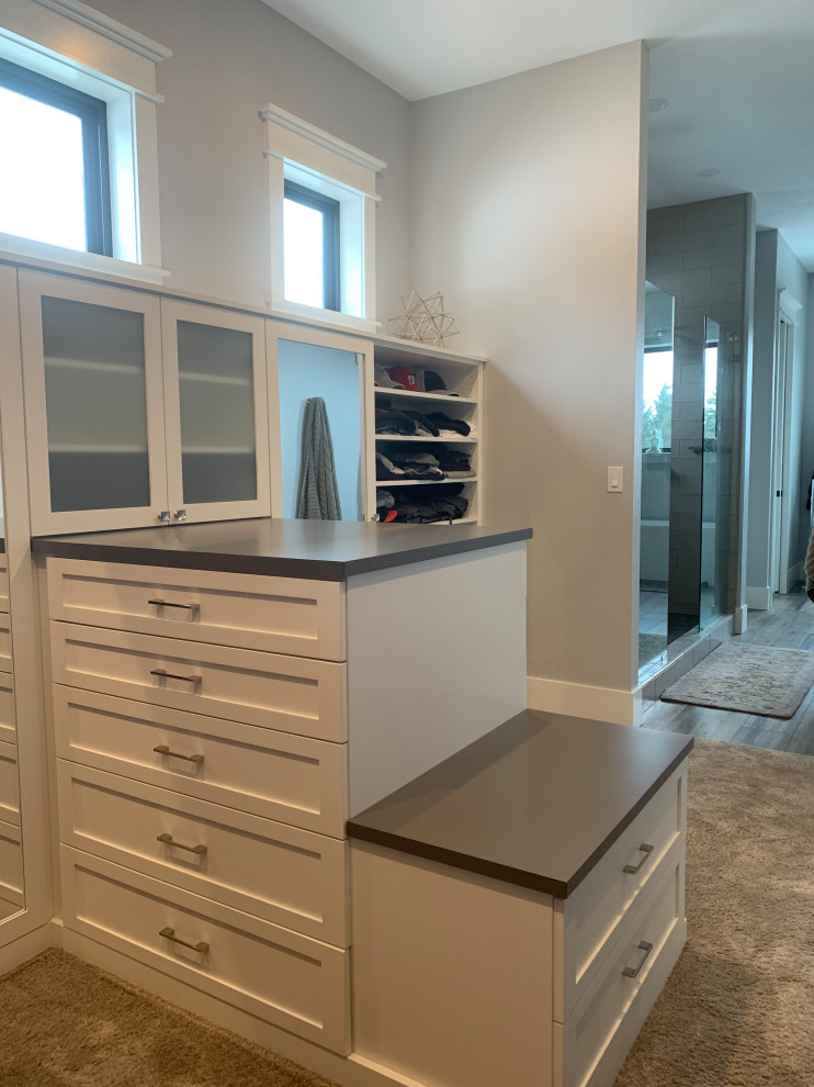 Inspiration for a large country gender-neutral carpeted and gray floor walk-in closet remodel in Other with shaker cabinets and white cabinets