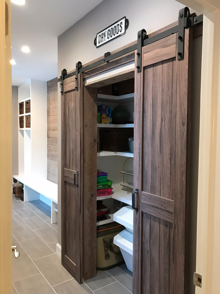 Example of a mid-sized minimalist porcelain tile and gray floor reach-in closet design in Denver