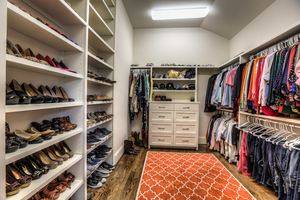 Walk-in closet - craftsman gender-neutral medium tone wood floor walk-in closet idea in Houston with shaker cabinets and white cabinets