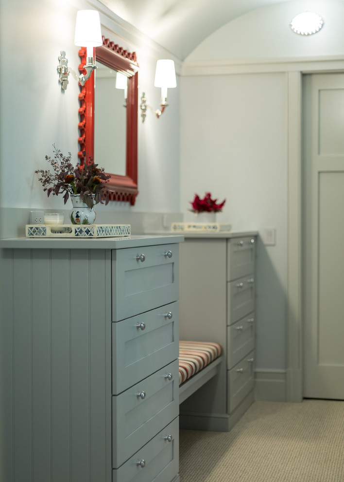 Photo of a medium sized classic gender neutral dressing room in Milwaukee with recessed-panel cabinets, grey cabinets and carpet.