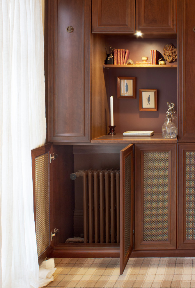 Photo of a traditional dressing room for men in New York with recessed-panel cabinets, medium wood cabinets, carpet and multi-coloured floors.