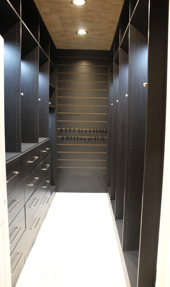 Inspiration for an expansive modern gender neutral walk-in wardrobe in Dallas with open cabinets and dark wood cabinets.