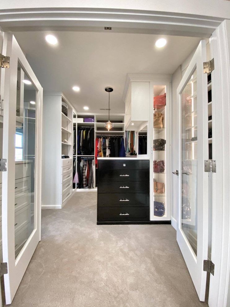 Large classic walk-in wardrobe for women in Other with shaker cabinets, white cabinets, carpet and grey floors.